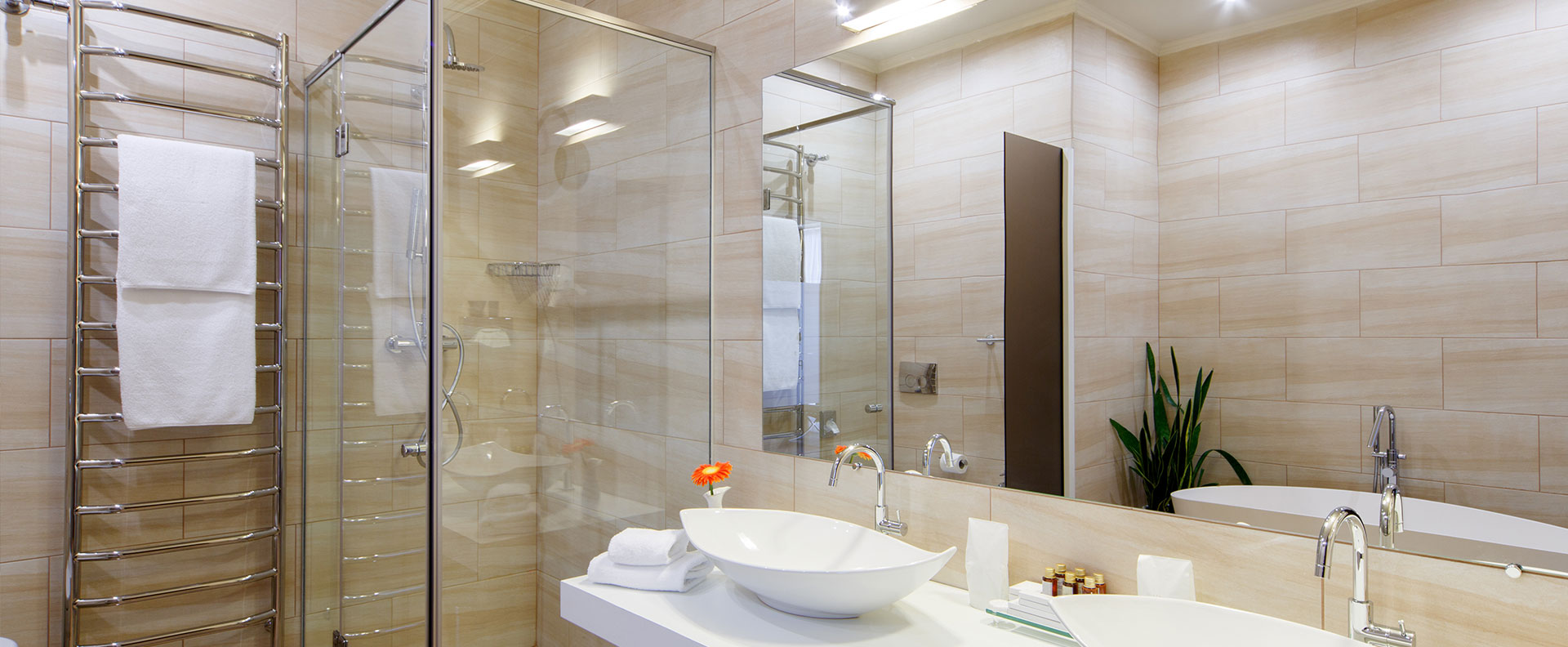 Modern bathroom with frameless shower glass and a large vanity mirror