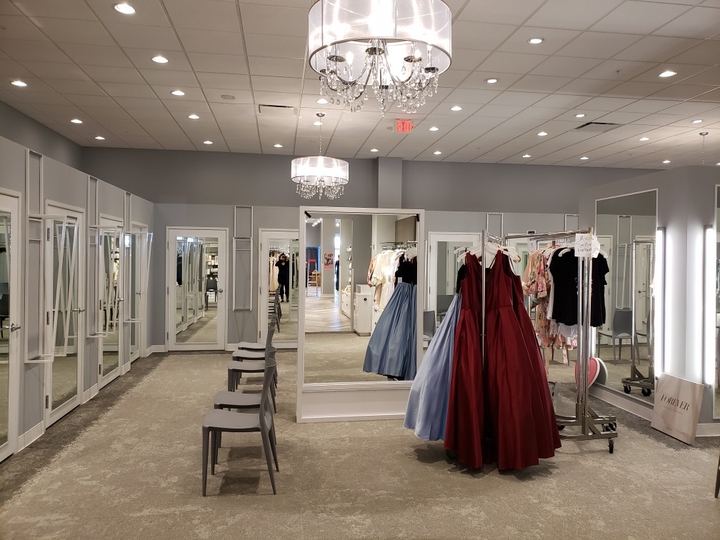 Formalwear boutique with mirrored fitting-room doors