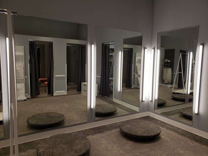 Bridal boutique fitting area with floor-to-ceiling mirrors