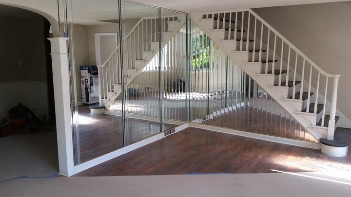 Custom beveled mirror panels installed along a residential staircase wall