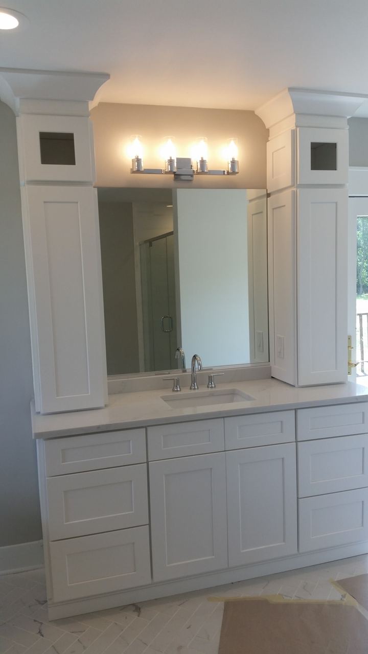 Vanity mirror over a stacked-stone backsplash
