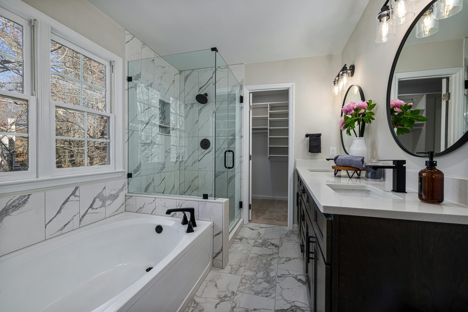 Modern bathroom with frameless glass shower installed by Illusions